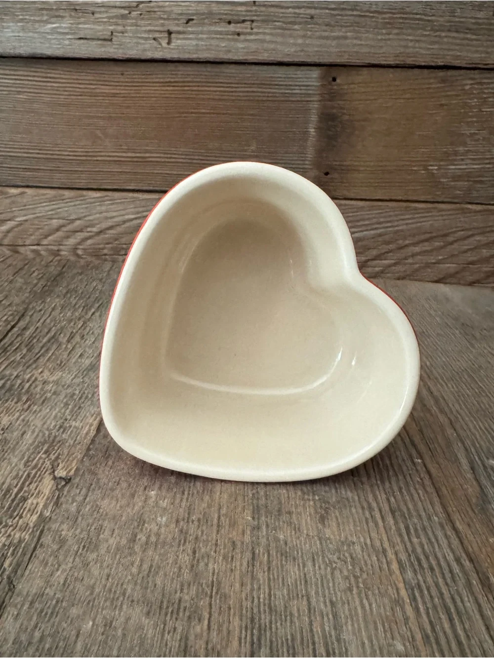 Red Le Creuset heart-shaped stoneware ramekin